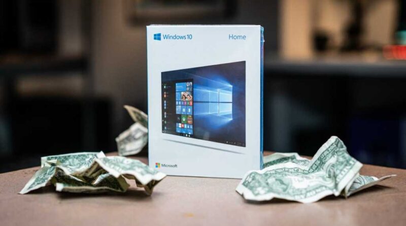 Windows 10 boxed on table with crumpled money