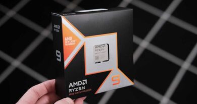 AMD Ryzen 9 9950X3D in retail box held by one corner - right angle
