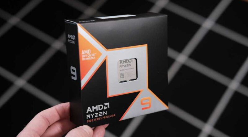 AMD Ryzen 9 9950X3D in retail box held by one corner - right angle