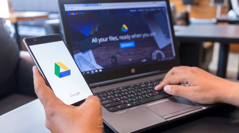 Google Drive on phone in hand and on laptop on desk