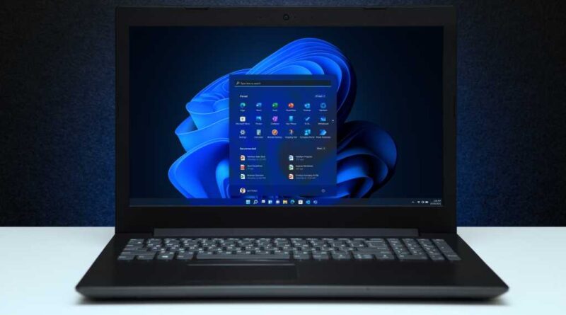 Windows 11 laptop with Start menu showing front hero