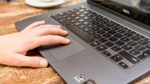 Hand on laptop touchpad