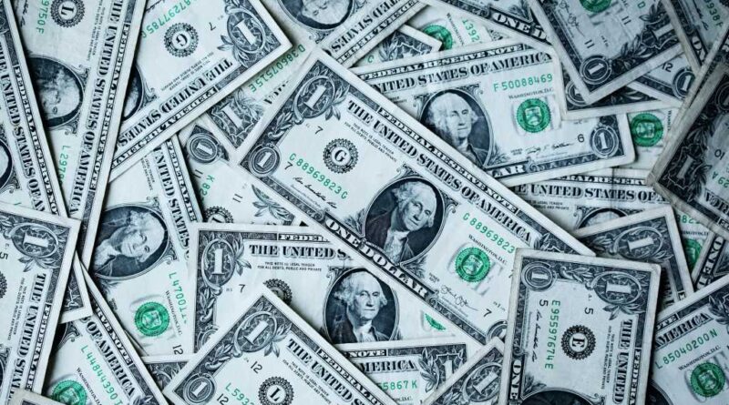 Dollar bills scattered in a pile