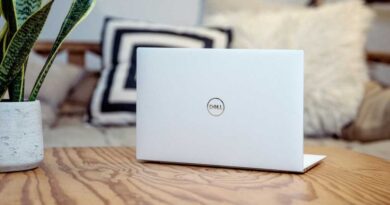 Dell laptop on wooden desk at home