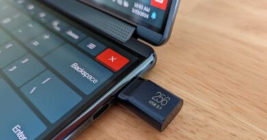 Samsung 256GB USB drive plugged into Lenovo Yoga Book 9i laptop