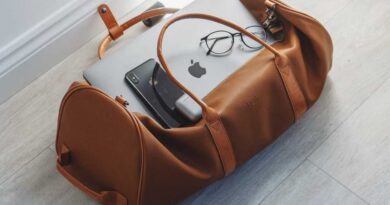Duffel bag with iPhone, MacBook, and Airpods