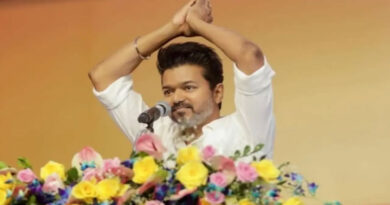 Vijay fan hangs dangerously to hand him a book