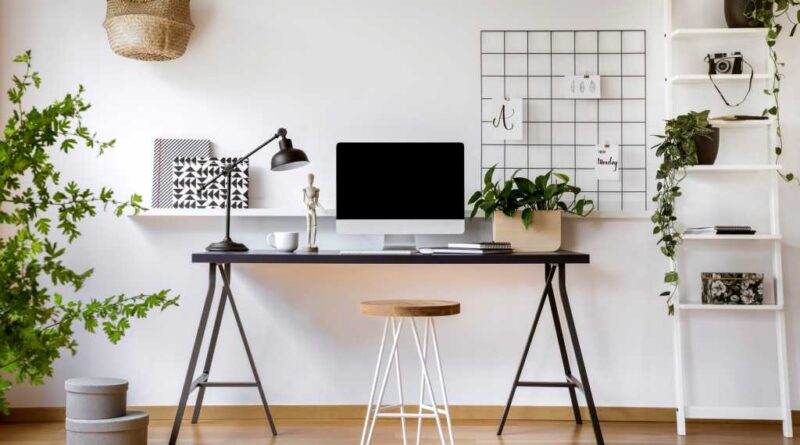 Clean home office desk workstation setup with lots of plants around