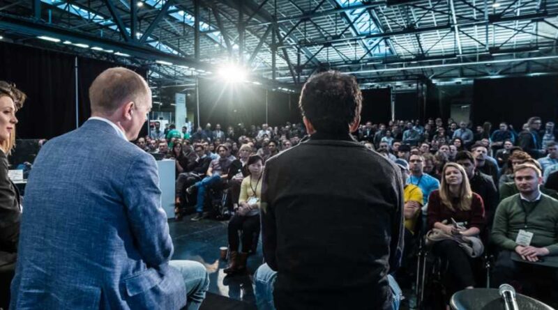Three speakers face the crowd at TechCrunch Disrupt