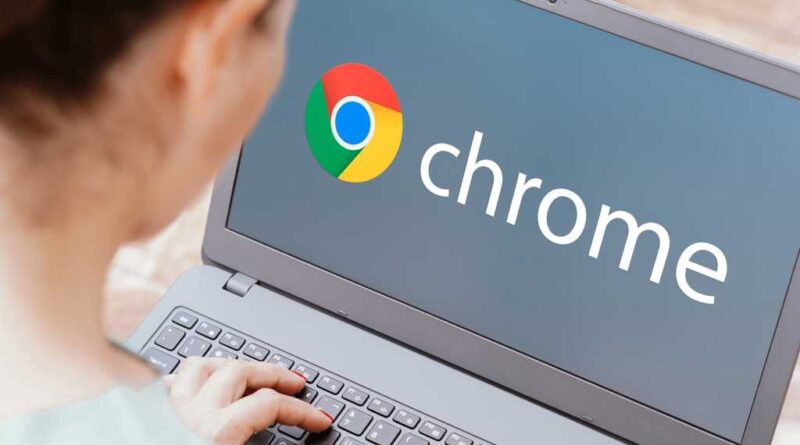 Chrome logo on laptop screen over the shoulder as woman types