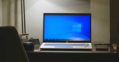 Windows 10 laptop on a desk in dramatic lighting