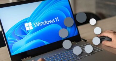 Windows 11 laptop with loading icon on top