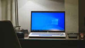 Windows 10 laptop on a desk in dramatic lighting