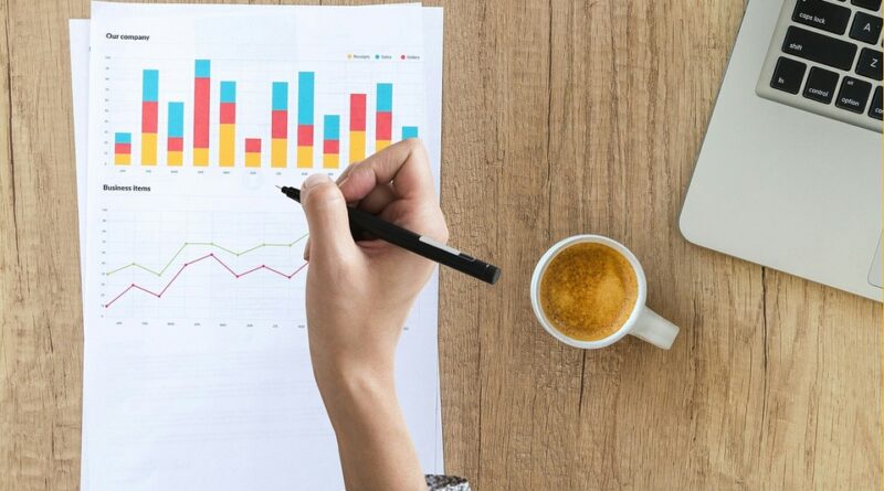 Windows 11 logo on phone sitting on laptop keyboard hero