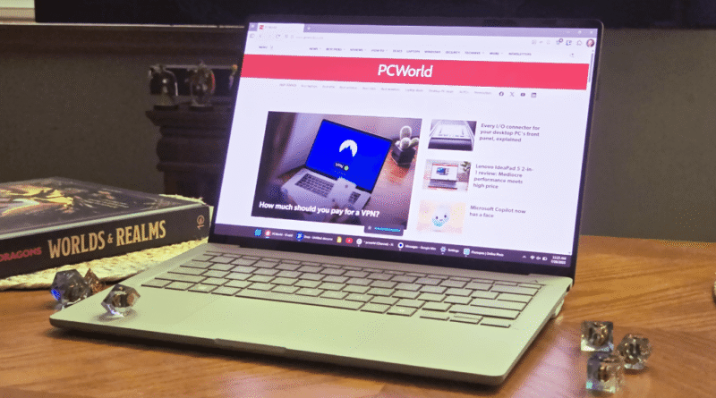 Asus Zenbook A14 laptop on table with dice and book