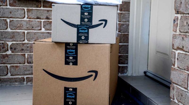 Amazon box packages delivered at front door of house