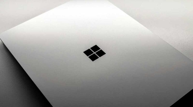 Windows laptop with lid closed on ominous white background surface hero