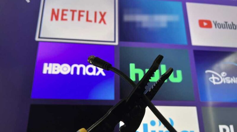 Roku home screen with a cord being cut in front of it