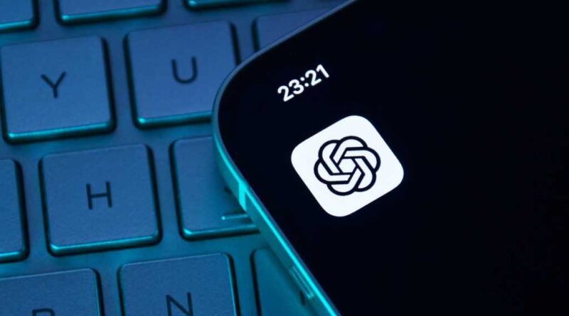 ChatGPT app icon on iPhone sitting on top of darkened keyboard