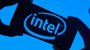 Intel logo on smartphone silhouette held in fingers