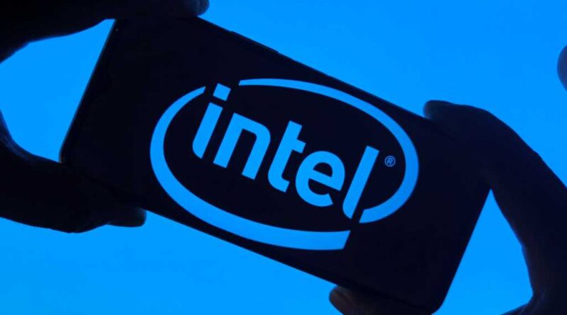 Intel logo on smartphone silhouette held in fingers