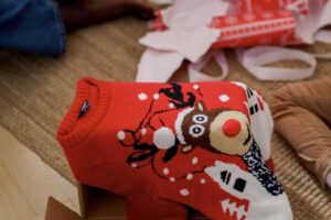 Holiday sweater among unwrapped gifts