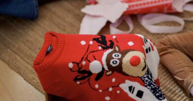 Holiday sweater among unwrapped gifts