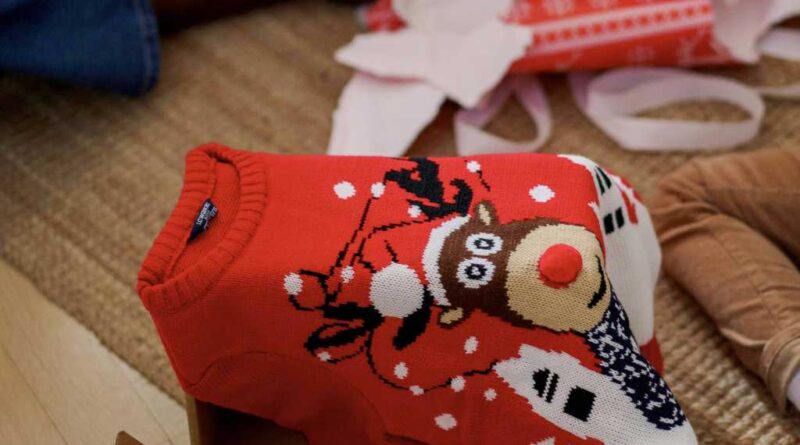 Holiday sweater among unwrapped gifts