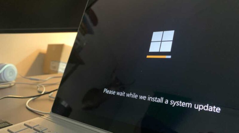 Windows 11 system update message on a laptop screen