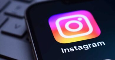 Instagram app icon on a phone screen on a laptop keyboard