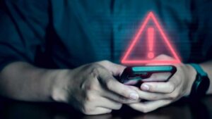 Man on phone with security alert warning