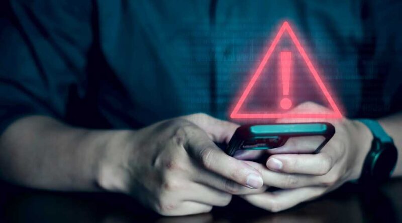 Man on phone with security alert warning