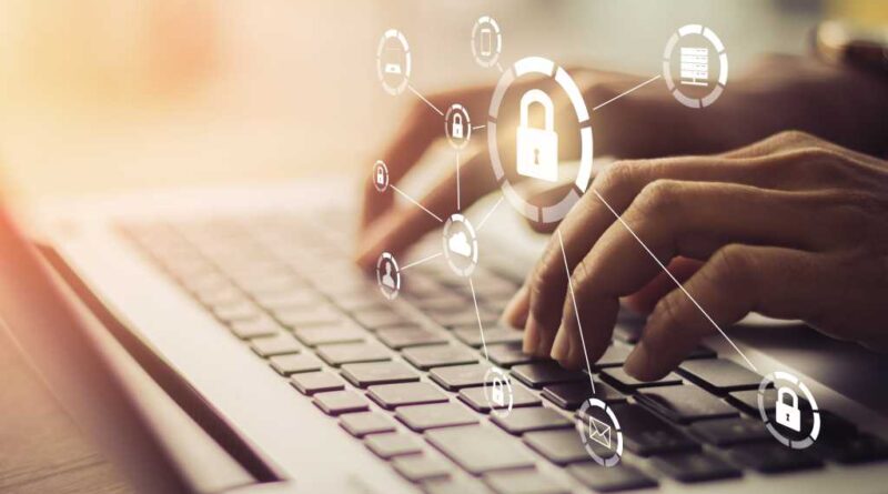 Man on laptop with protective security locking symbols