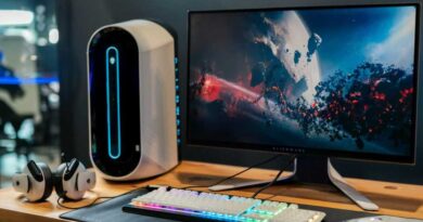 Alienware monitor on a high-tech wooden desk setup