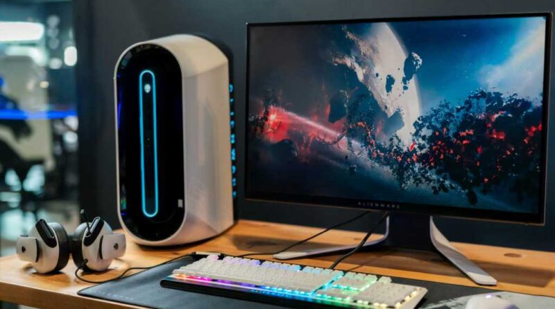 Alienware monitor on a high-tech wooden desk setup