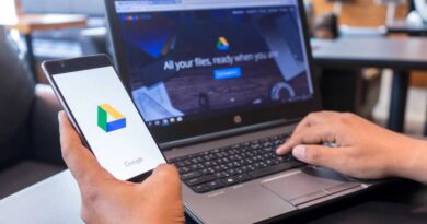 Google Drive on phone in hand and on laptop on desk