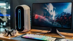 Alienware monitor on a high-tech wooden desk setup