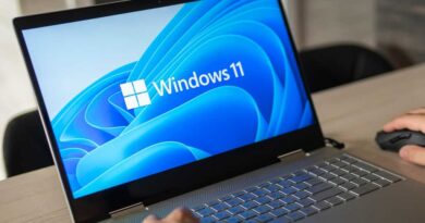 Man working on a Windows 11 laptop clearly on screen