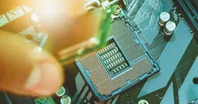 Fingers placing CPU processor chip into motherboard socket