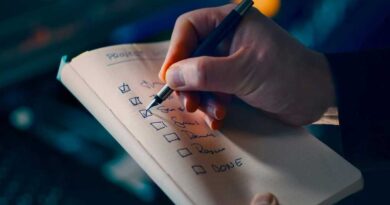 Pen checklist crossing off in front of a desktop PC setup