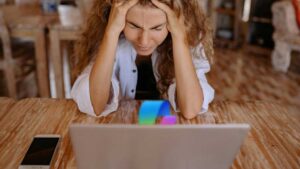 oh god why copilot why woman frustrated with laptop