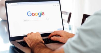 Man typing on laptop with Google Chrome on screen