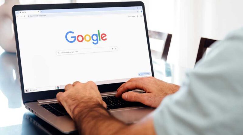 Man typing on laptop with Google Chrome on screen