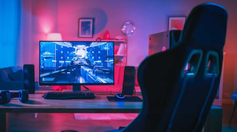Gaming PC rig with RGB workstation and empty gaming chair