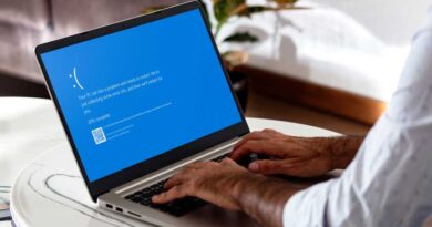 Windows laptop with a Blue Screen of Death error on screen