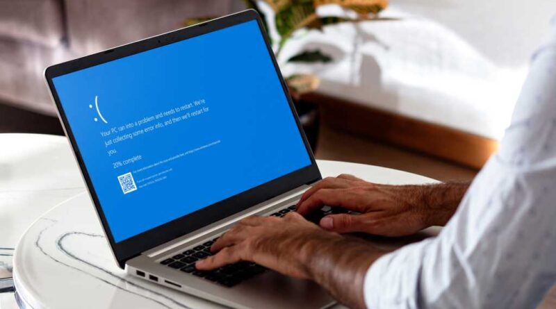 Windows laptop with a Blue Screen of Death error on screen