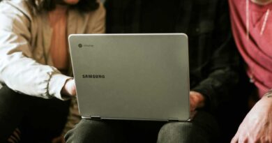Samsung Chromebook in lap of user being shared with two friends
