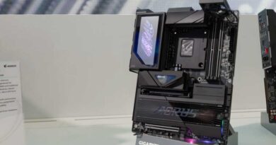 Black Gigabyte motherboard with Aorus branding and black tape over the CPU socket details sits on display on a white table at Computex 2026 in Taiwan.