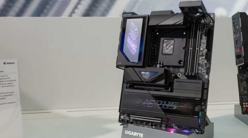 Black Gigabyte motherboard with Aorus branding and black tape over the CPU socket details sits on display on a white table at Computex 2026 in Taiwan.