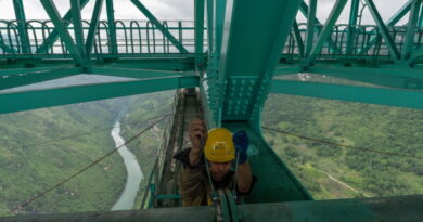 A worker tightens bolts on a pipe of the Huajiang Grand Canyon Bridge, considered to be the world’s highest bridge, in Anshun in southwestern China